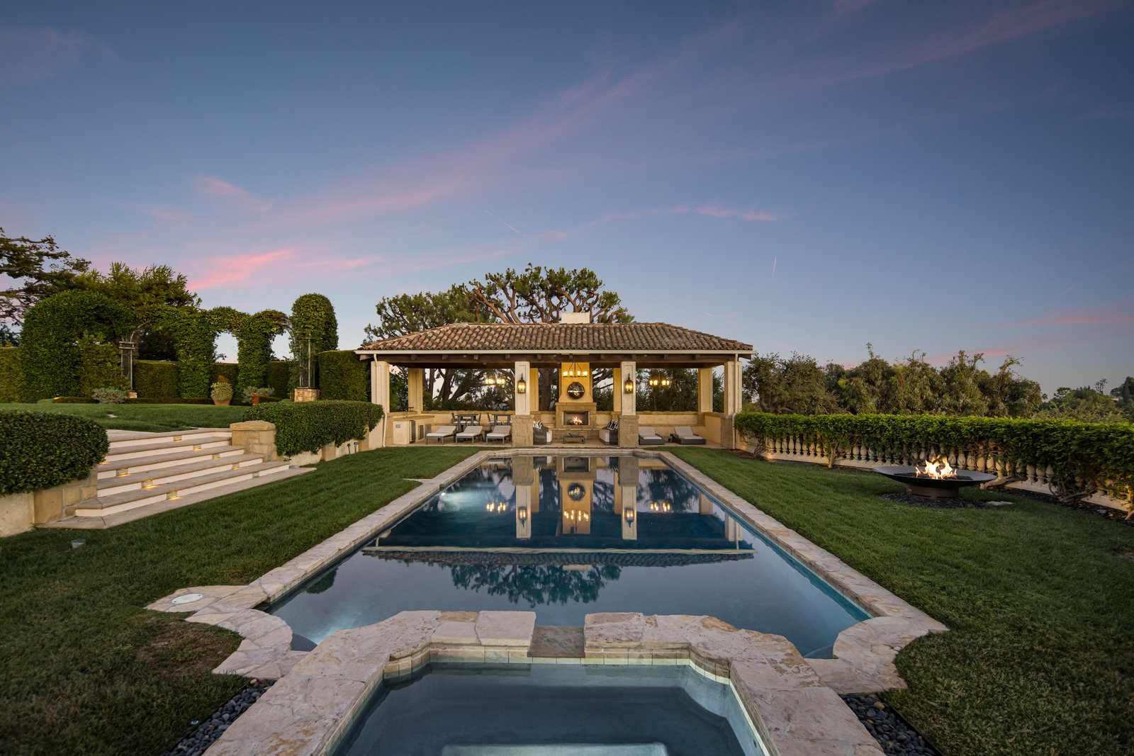 The estate pool and cabana at twilight