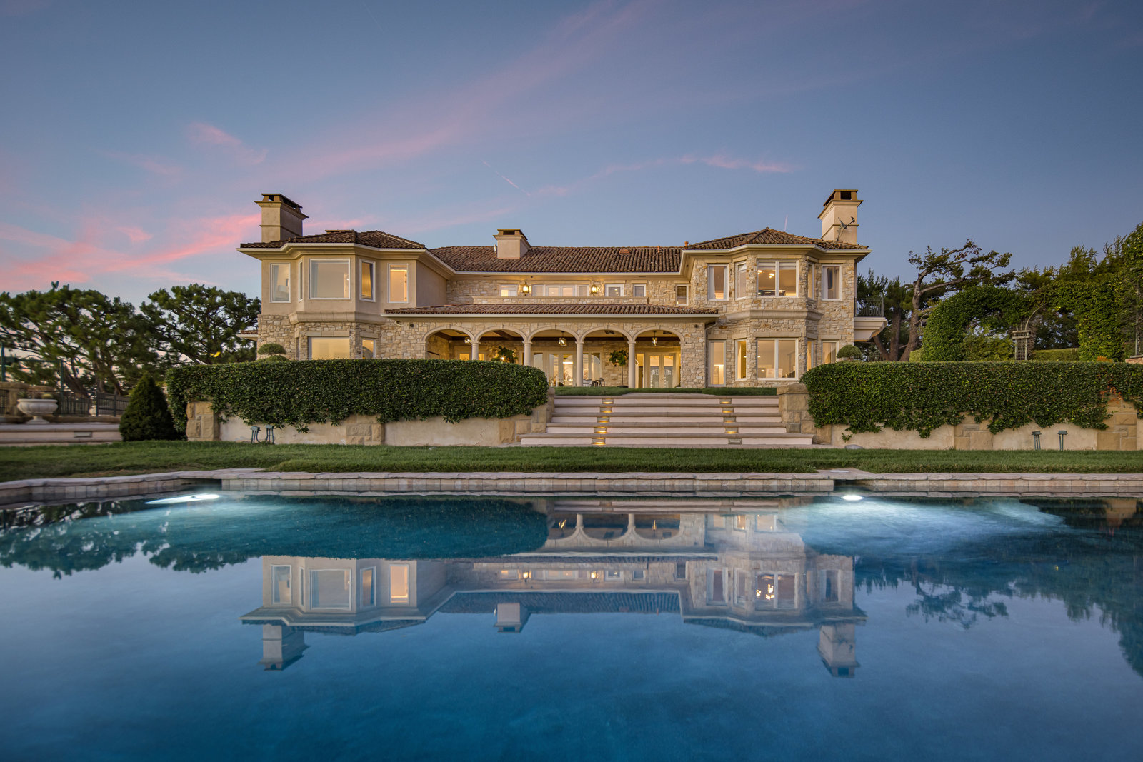 Pool reflection and main residence at dusk