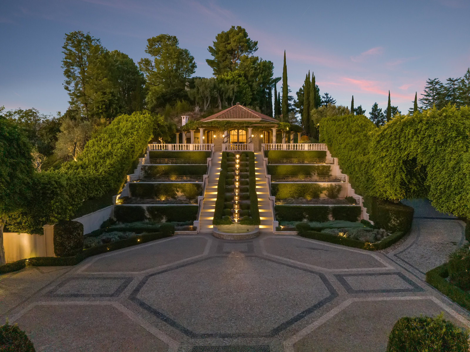Illuminated garden stair and fountain at dusk