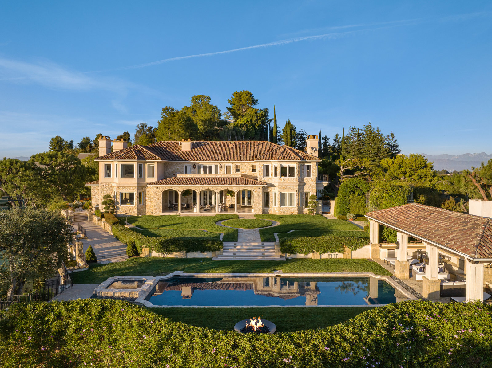 Main residence, pool, and cabana in daylight
