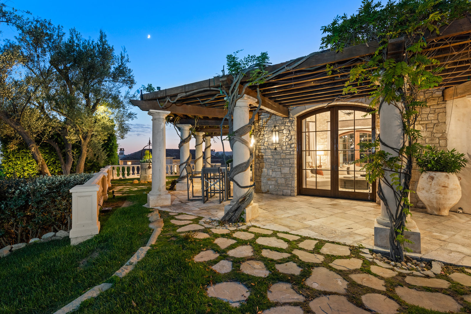 Stone terrace, French doors, and evening garden light