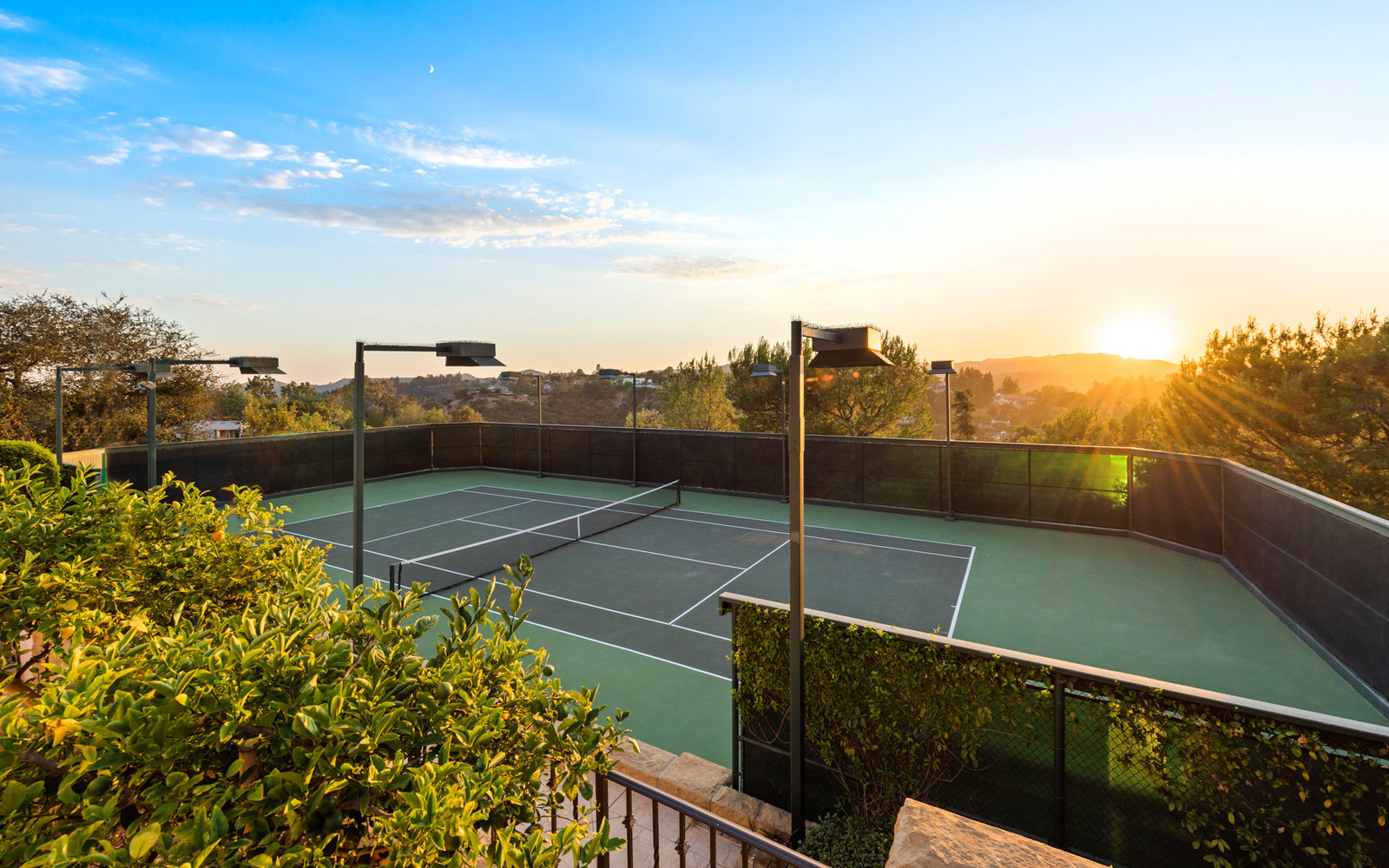 Private tennis court at sunset
