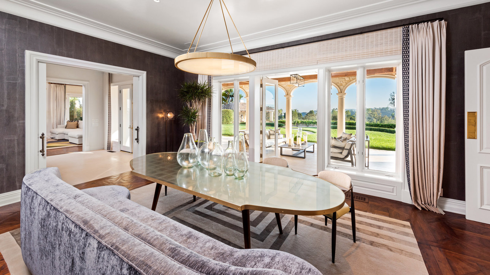 Dining room opening to the loggia and lawn