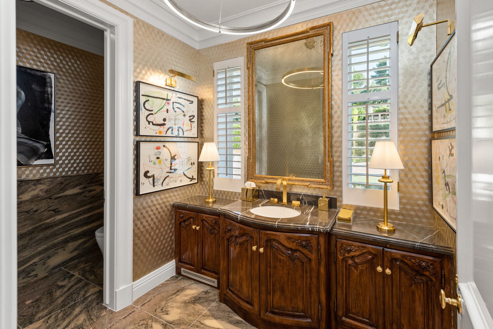 Guest bath with brass fixtures and art