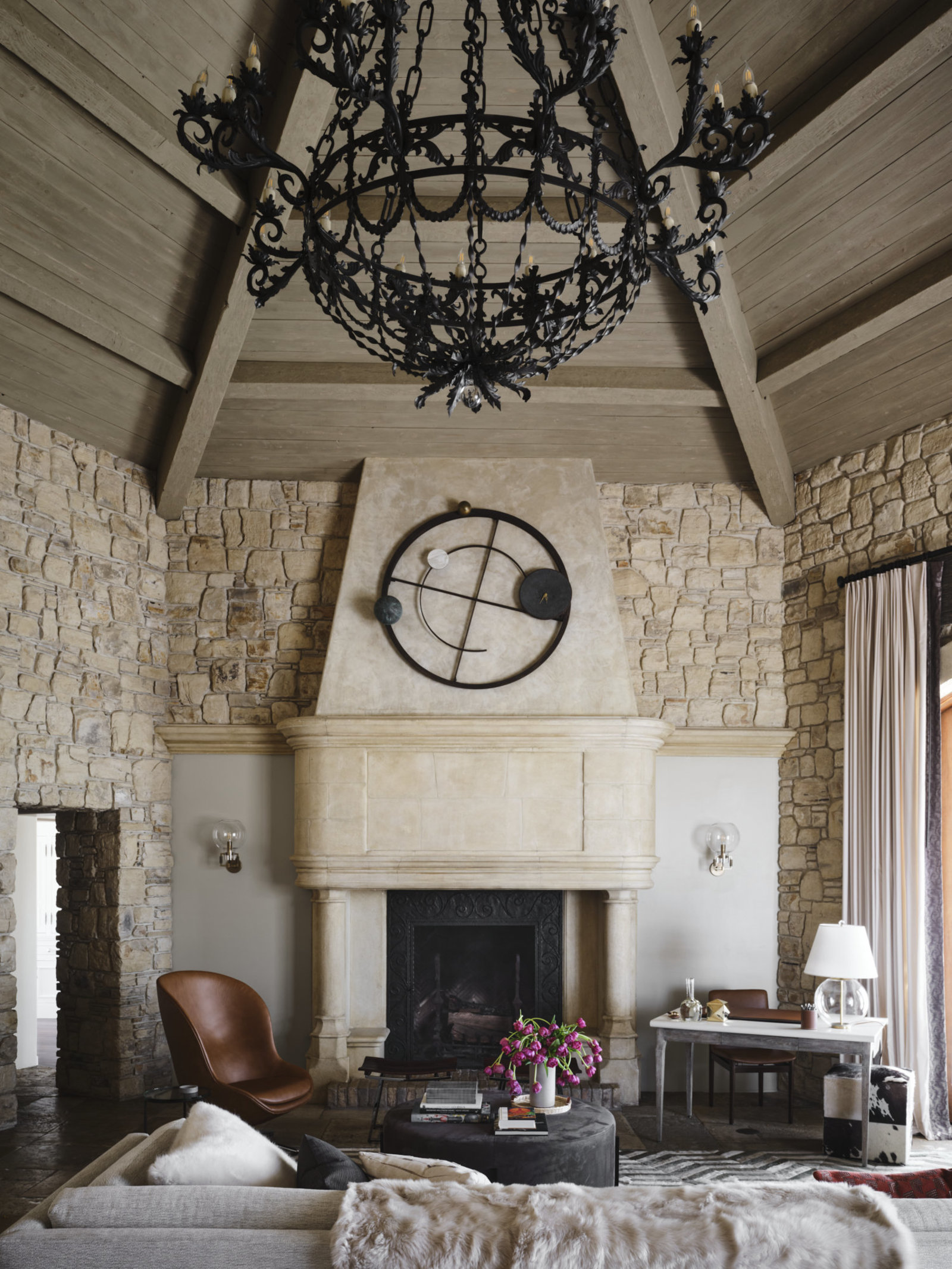 Grand stone fireplace and chandelier