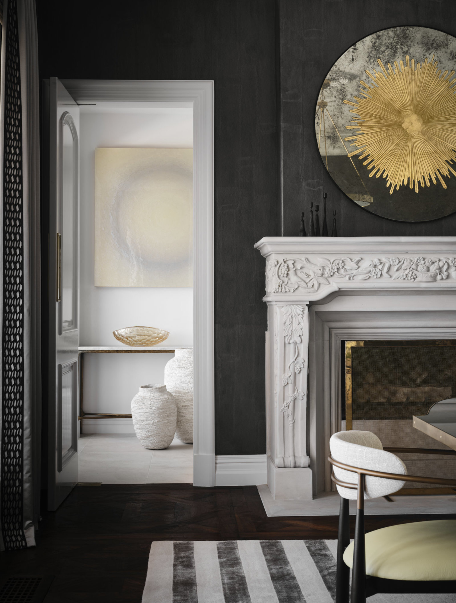 Detailed dining room fireplace and gold mirror